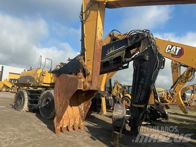 CAT M325CMH Caricatronchi con base su rimorchio